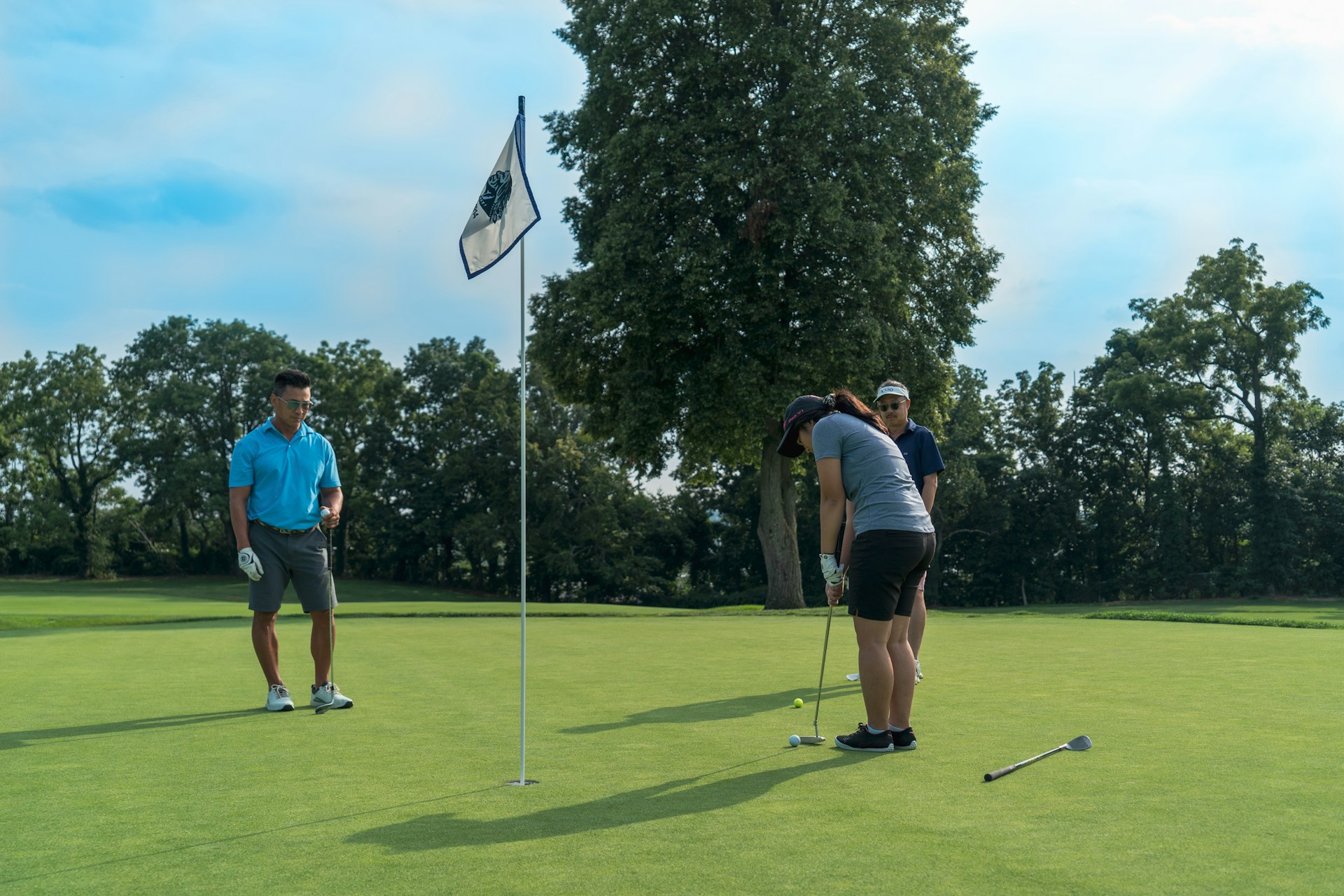 Golf professional helping a golfer with a putter fitting